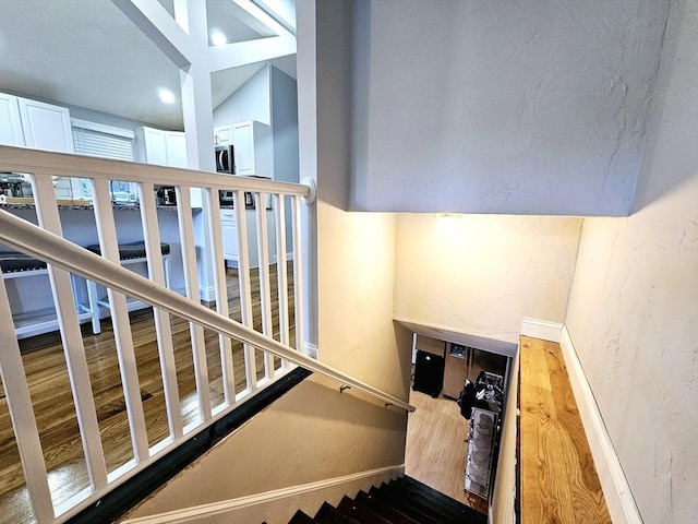 20 Upland Rd, Marlborough, MA 01752 - stairway with wood finished floors and a textured wall
