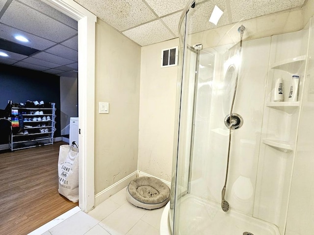 20 Upland Rd, Marlborough, MA 01752 - bathroom featuring a drop ceiling, a shower stall, and wood finished floors