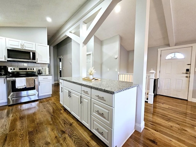 20 Upland Rd, Marlborough, MA 01752 - kitchen featuring appliances with stainless steel finishes, white cabinetry, dark wood finished floors, and light stone counters