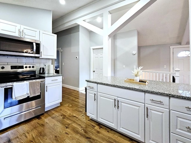 20 Upland Rd, Marlborough, MA 01752 - kitchen featuring stainless steel appliances, white cabinetry, dark wood-style floors, light stone counters, and decorative backsplash