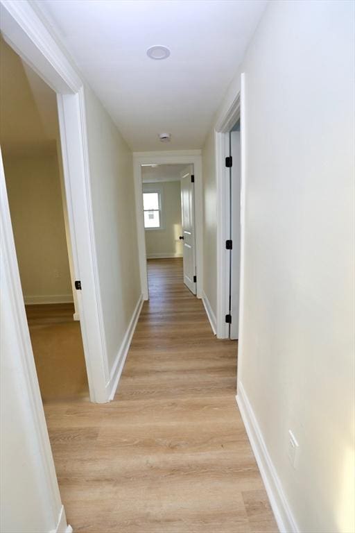 corridor with light wood-type flooring