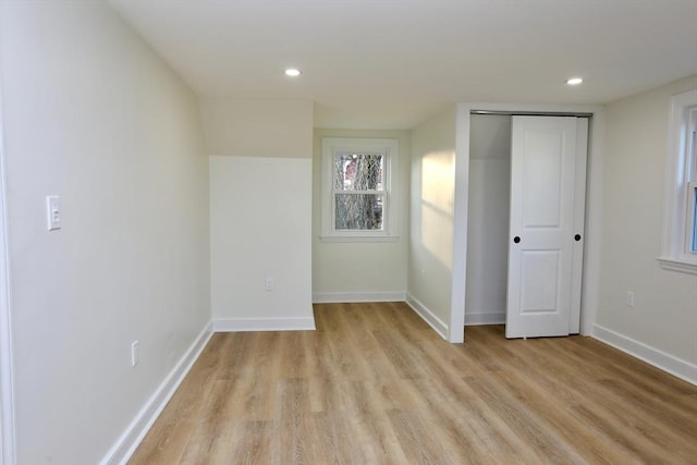 unfurnished bedroom featuring light hardwood / wood-style floors and a closet