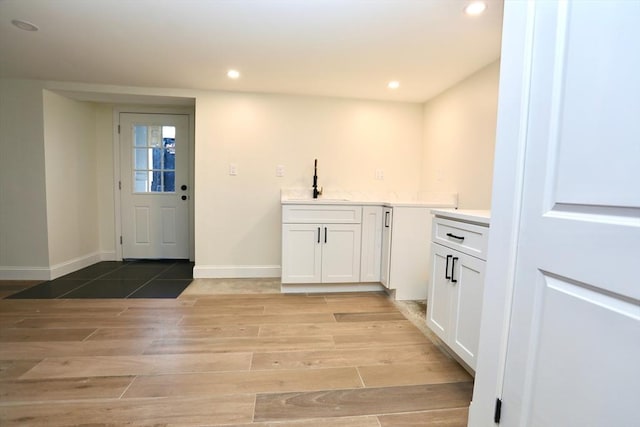 interior space with light hardwood / wood-style flooring and sink