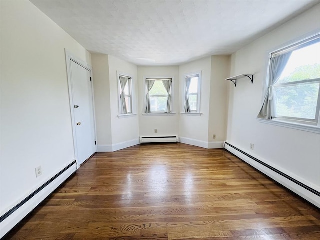 189 Concord Ave Unit 3, Cambridge, MA 02138 - spare room with baseboard heating and wood finished floors