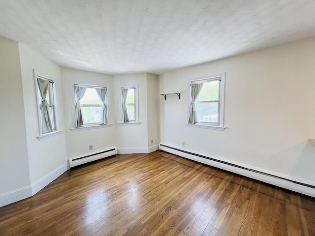 189 Concord Ave Unit 3, Cambridge, MA 02138 - spare room with baseboard heating, wood finished floors, and a textured ceiling