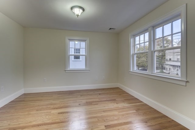 empty room with light hardwood / wood-style floors