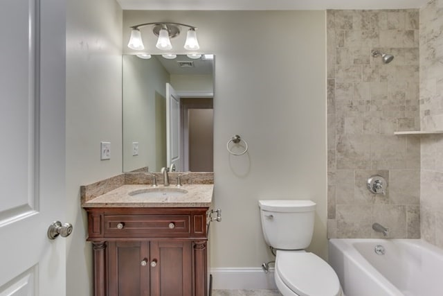 full bathroom featuring tiled shower / bath, toilet, and vanity