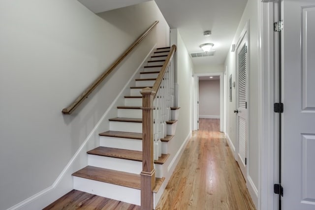 stairs featuring hardwood / wood-style flooring