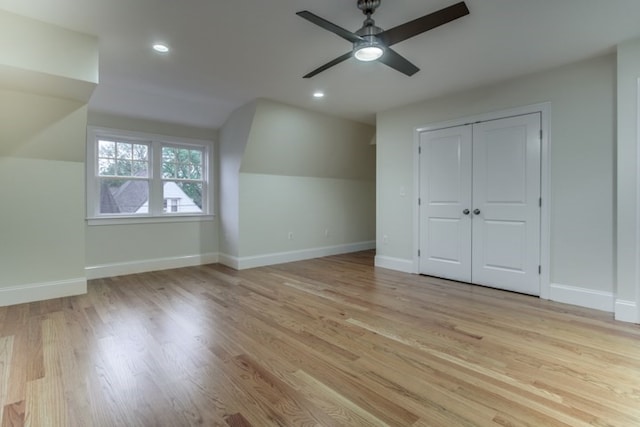 additional living space featuring light wood-type flooring, vaulted ceiling, and ceiling fan