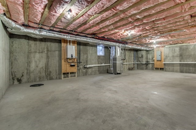 basement with electric panel and heating unit