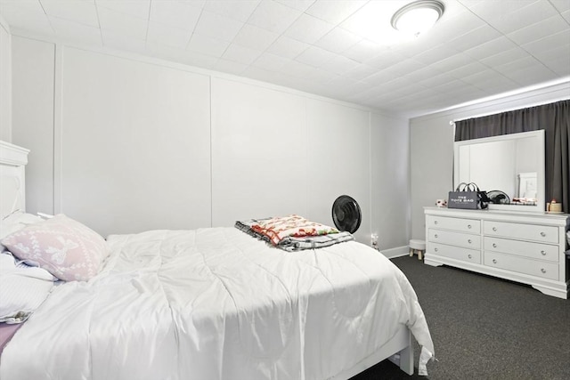 bedroom featuring dark colored carpet
