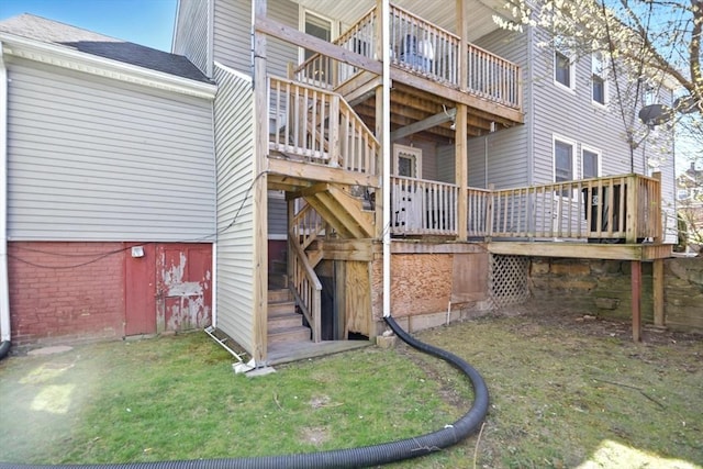 back of house featuring a shingled roof, stairs, and a deck