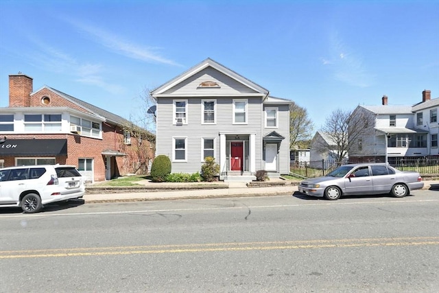 greek revival house featuring fence