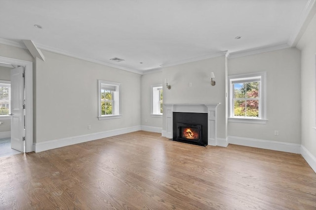 unfurnished living room with ornamental molding and light hardwood / wood-style flooring