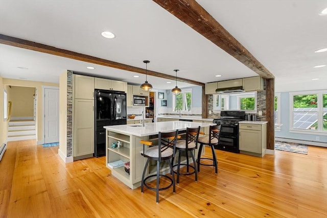 94 Kimball Rd, Amesbury, MA 01931 - kitchen with black appliances, beam ceiling, light wood finished floors, light countertops, and recessed lighting