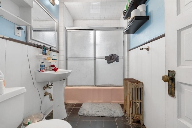 69 Conwell Ave, Somerville, MA 02144 - full bathroom featuring radiator heating unit, toilet, tile patterned flooring, and combined bath / shower with glass door