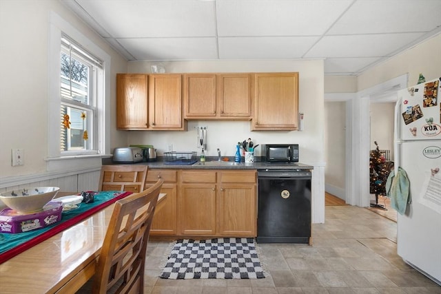 69 Conwell Ave, Somerville, MA 02144 - kitchen featuring black appliances, a drop ceiling, dark countertops, and a sink