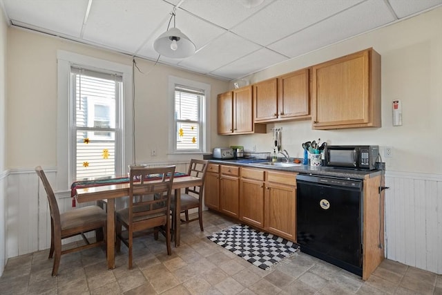 69 Conwell Ave, Somerville, MA 02144 - kitchen with black appliances, a sink, wainscoting, a paneled ceiling, and dark countertops