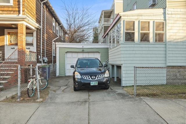 69 Conwell Ave, Somerville, MA 02144 - view of side of home with concrete driveway, a garage, and fence