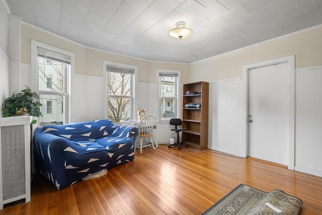 69 Conwell Ave, Somerville, MA 02144 - sitting room with light wood-style floors, ornamental molding, wainscoting, and a decorative wall