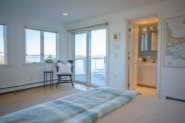 18 Wendy Way, Dennis, MA 02670 - bedroom featuring a baseboard radiator, ensuite bathroom, multiple windows, and access to exterior
