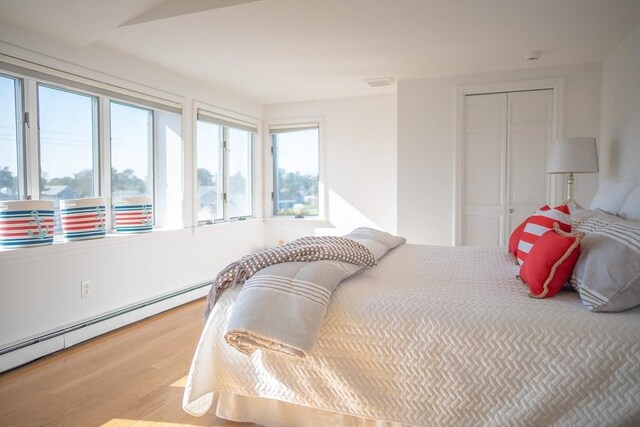 18 Wendy Way, Dennis, MA 02670 - bedroom with a closet, a baseboard radiator, wood finished floors, and multiple windows