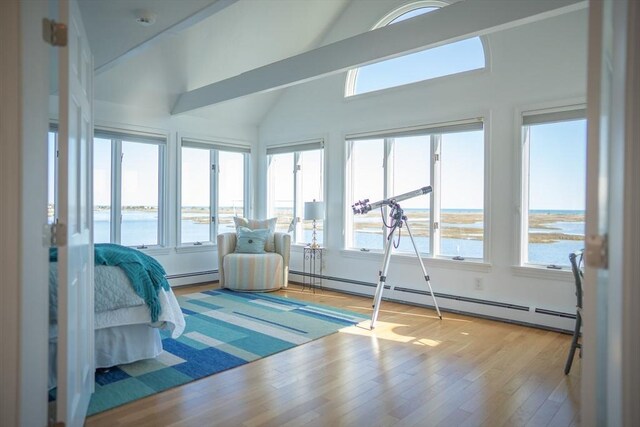 18 Wendy Way, Dennis, MA 02670 - interior space featuring a water view, high vaulted ceiling, a baseboard heating unit, and wood finished floors