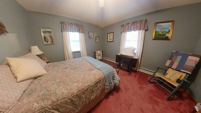 carpeted bedroom with ceiling fan and a baseboard radiator