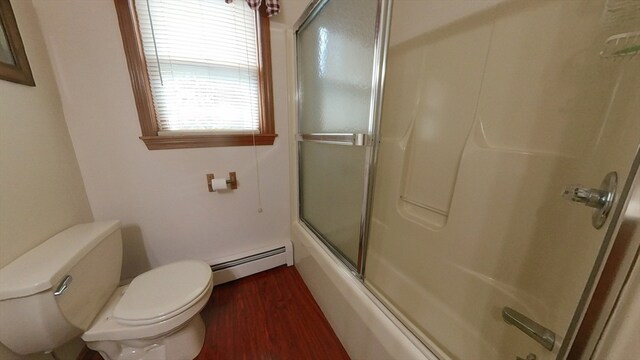 bathroom with bath / shower combo with glass door, a baseboard radiator, hardwood / wood-style flooring, and toilet