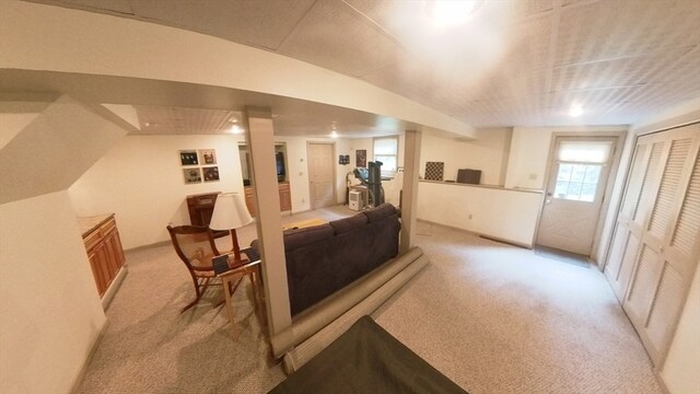 interior space with lofted ceiling and light carpet