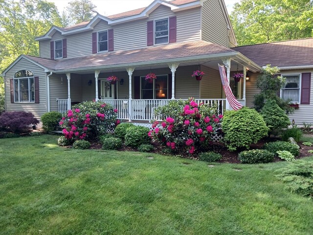 view of front of house featuring a porch and a front lawn