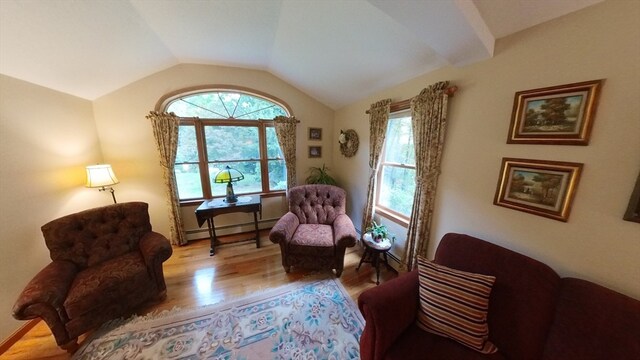 sitting room featuring a baseboard radiator, lofted ceiling, and light hardwood / wood-style floors