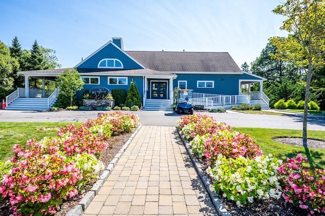 16 Twin Oaks Dr Unit 732, Mashpee, MA 02649 - view of front of house with covered porch, a chimney, and stairs