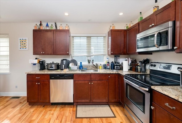 54 Primrose St Unit 3, Haverhill, MA 01830 - kitchen featuring stainless steel appliances, a sink, light wood-type flooring, light stone countertops, and recessed lighting
