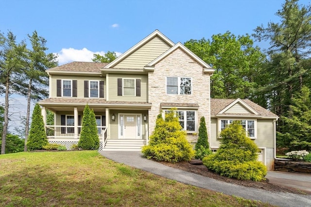 3 Chad Ln, Sterling, MA 01564 - view of front of house featuring a front lawn, a porch, a garage, driveway, and stone siding