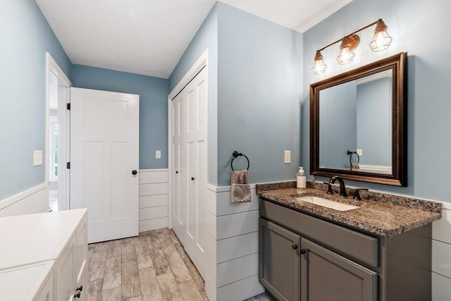3 Chad Ln, Sterling, MA 01564 - bathroom featuring vanity, a wainscoted wall, and wood finished floors