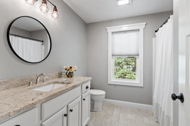 3 Chad Ln, Sterling, MA 01564 - bathroom with vanity, toilet, baseboards, and wood finished floors
