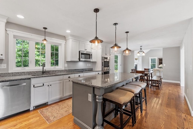 3 Chad Ln, Sterling, MA 01564 - kitchen featuring stainless steel appliances, a sink, a breakfast bar area, light wood-type flooring, and recessed lighting