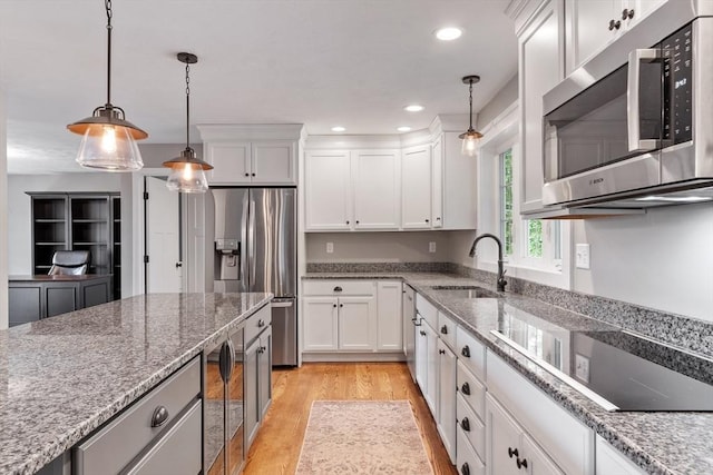 3 Chad Ln, Sterling, MA 01564 - kitchen featuring stainless steel appliances, a sink, light wood-style flooring, white cabinets, and pendant lighting