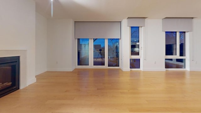 unfurnished living room with light hardwood / wood-style floors