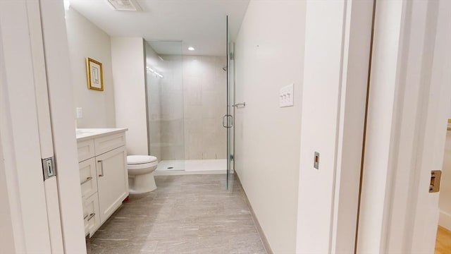 bathroom with vanity, toilet, and walk in shower