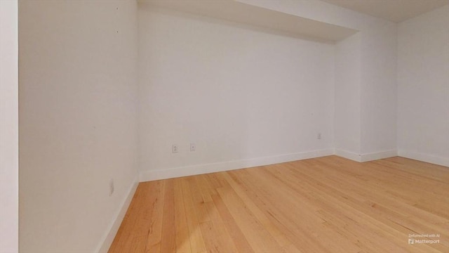 unfurnished room with hardwood / wood-style flooring