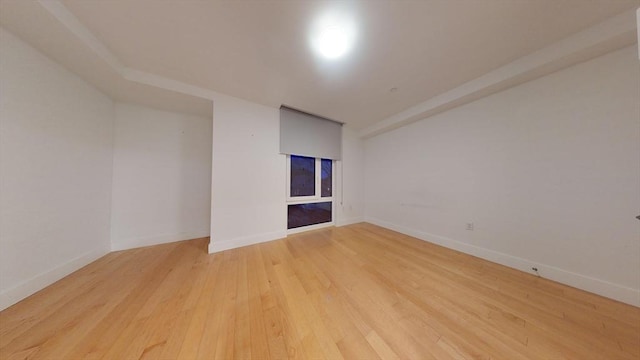 unfurnished room with light wood-type flooring