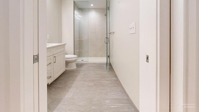 bathroom featuring vanity, toilet, and walk in shower