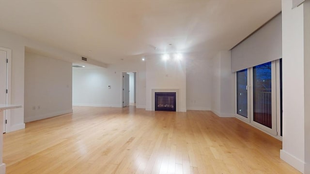 unfurnished living room with light wood-type flooring