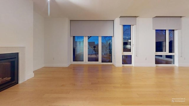 unfurnished living room with light hardwood / wood-style flooring