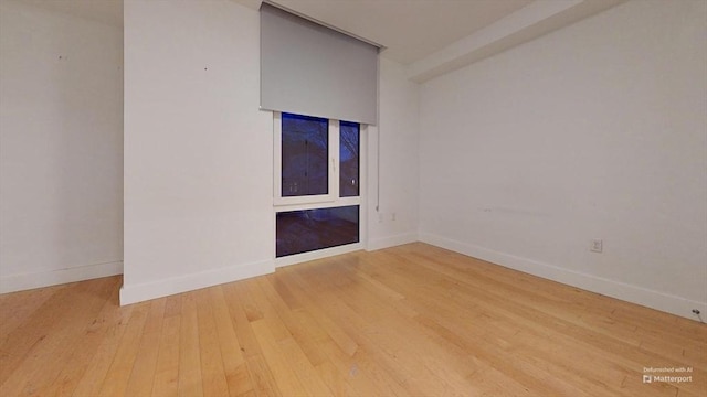 unfurnished room with hardwood / wood-style flooring