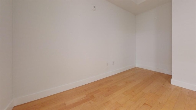 spare room with hardwood / wood-style floors