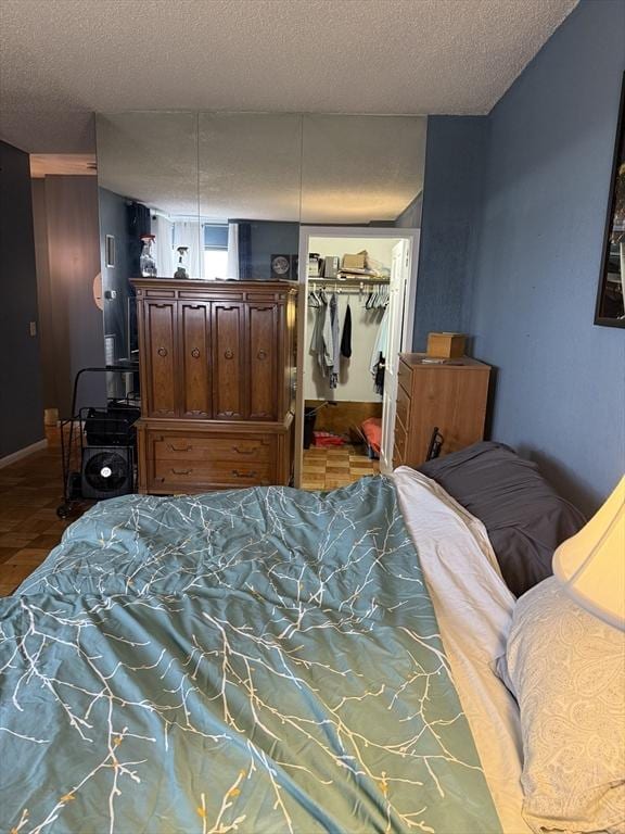 bedroom featuring a textured ceiling and a closet