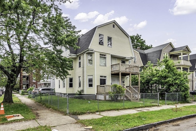 77-79 Grenada Ter, Springfield, MA 01108 - view of front facade with a gambrel roof, a balcony, a gate, and roof with shingles